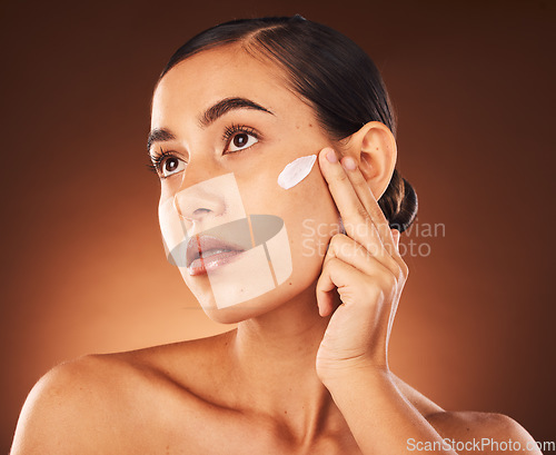 Image of Skincare, face and woman with beauty cream product for healthy facial grooming or glowing skin in studio background. Cosmetics, dermatology or girl model applying natural sunscreen lotion with mockup