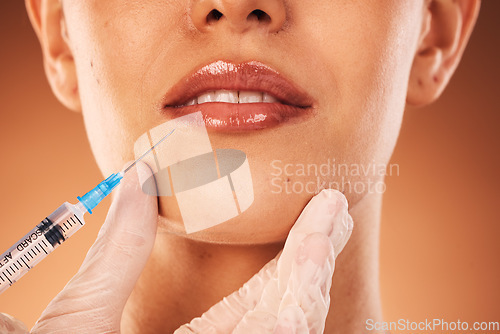 Image of Beauty, lips and botox with a woman customer in studio on a brown background for plastic surgery. Doctor, trust and collagen with a female client getting an injection in her lip with a syringe