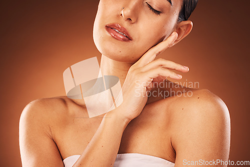 Image of Skincare, health and woman in a studio for wellness, natural and cosmetic facial treatment. Sensual, beauty and girl model with a face, skin or self care routine isolated by gradient brown background