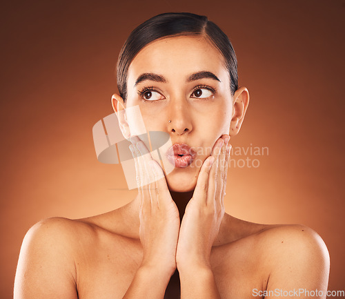 Image of Beauty, skincare and woman in a studio with a natural, health and wellness face treatment. Self care, pout and female model from Mexico with facial skin routine isolated by gradient brown background.