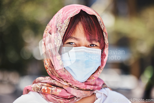 Image of Muslim, covid and woman in face mask for compliance or safety in a city in Turkey after a medical coronavirus vaccine. Hijab, portrait and Islamic girl standing outdoors in a pandemic with protection