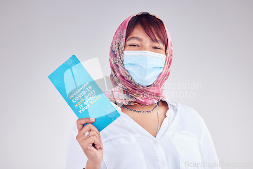 Image of Covid, Muslim woman and mask for vaccine card, protection and healthy for wellness, happy and on grey studio background. Islam lady, face cover and vaccination proof for travel, safety and corona.