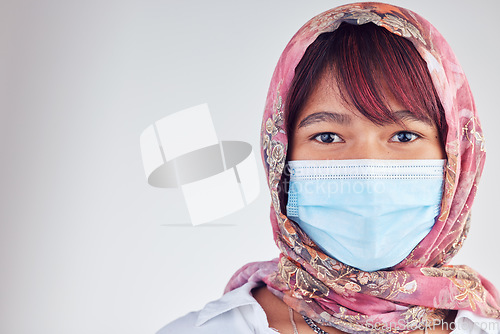Image of Muslim, covid and face of woman in hijab on gray studio background for coronavirus security compliance mockup. Covid 19 healthcare, islam and new normal virus safety for Islamic medical wellness