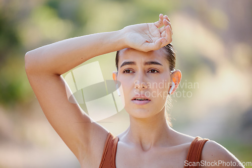 Image of Woman, fitness and rest, tired and breathing on a running break, listening to music on earphones on summer morning in Australia. Health, exercise and girl runner resting on outdoor workout.