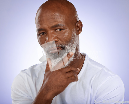 Image of Portrait, face and thinking with a senior black man in studio on a purple background with an idea. Confidence, serious and mindset with an elderly male pensioner contemplating on a wall background