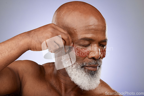 Image of Senior man, eyes mask and face skincare wellness in studio for beauty, cosmetics dermatology or skin treatment. Facial care, natural eyecare product and body care cosmetology in purple background