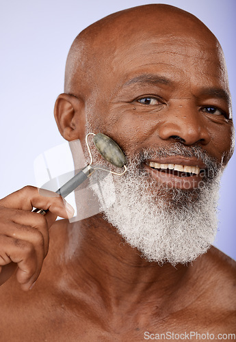 Image of Skincare, face roller and senior black man in studio on purple background for wellness, beauty and grooming. Dermatology, cosmetics and elderly male with jade roller for facial massage and treatment