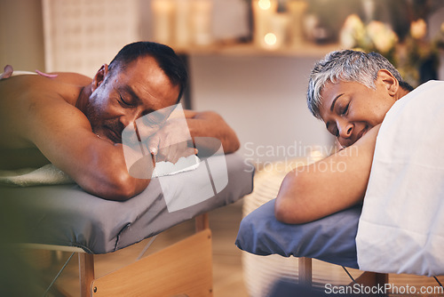 Image of Massage, relax and spa with a senior couple lying on a bed in a health or wellness center for luxury treatment. Health, zen and hospitality with a mature man and woman customer in a salon for therapy