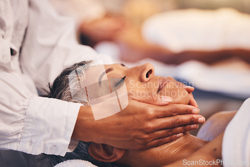 Image of Face massage, woman and relax at spa for wellness, luxury cosmetology and zen cosmetics. Facial aesthetics, beauty salon and physical therapy for healthy skincare of mature lady with body dermatology