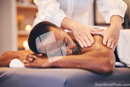 Image of Spa, back massage and hands of therapist with oil for physical therapy, health and wellness on table. Patient man on table to relax, peace and luxury zen treatment at a beauty salon for stress relief