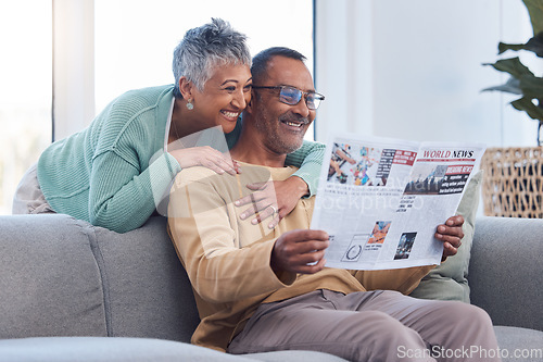 Image of Love, senior couple and reading newspaper, story or news article in living room home. Retirement, relax time and happy elderly man and woman embrace in house, hugging or cuddle together and bonding.