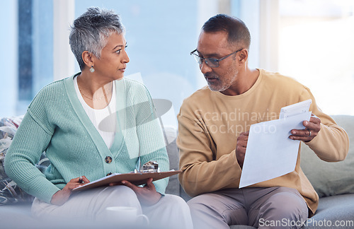 Image of Finance, mortgage and old couple with a budget on paper for insurance bills, financial investments or taxes. Management, partner and senior woman talking, speaking or planning for economy inflation