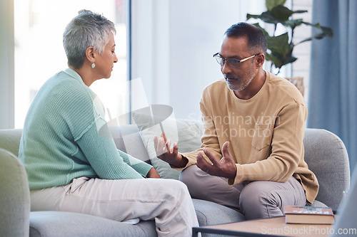 Image of Couple, talking and conversation during fight on sofa about marriage problems, conflict and communication. Divorce, argument and frustrated relationship of mature man, woman and sad partner in lounge