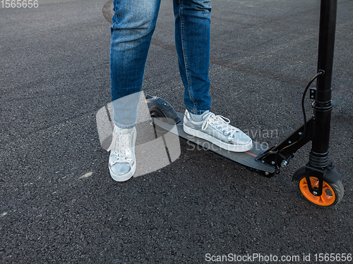 Image of Woman riding an electric scooter