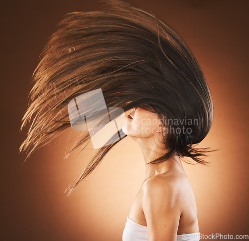 Image of Beauty, hair care and flip profile with a model on gradient background for cosmetics, transformation and shampoo for growth and shine. Model in studio for freedom, beauty salon and hairdresser