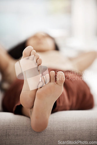 Image of Woman feet, relax and sleep on the sofa in home after work, rest and break on a friday in the house living room. Female relaxing, chilling and tired while sleeping in house, calm, quiet and lazy