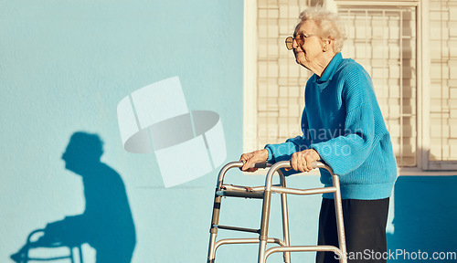 Image of Senior, walker and woman in a city with a disability, osteoporosis or arthritis walking with wall mockup. Relax fitness from leg rehabilitation after surgery with a elderly female walk for health