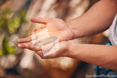 Image of Hands, pain and active hand of a man hiking and suffering from a medical emergency outdoor. Healthcare, injury and fitness with a palm of a male highlighted with overlay and glow in nature