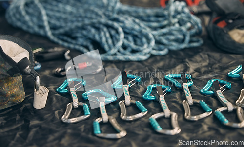 Image of Rope safety, climbing and rock mountain sports equipment to be safe and secure. Sports tool setup zoom of carabiner an hook tools for an outdoor, security and adventure experience in the mountains