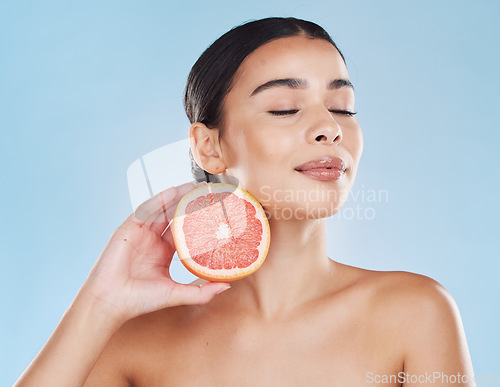 Image of Skincare, wellness beauty woman with grapefruit in hand with healthcare, cosmetic health and face model in studio. Portrait of girl skin, healthy fruit diet with vitamins and nutrition.