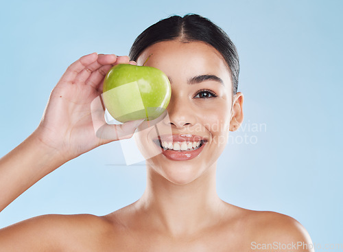 Image of Apple, beauty and woman in a face skincare portrait showing happy, dermatology and facial health results. Young girl doing detox with natural and organic acne products with fresh fruit nutrition