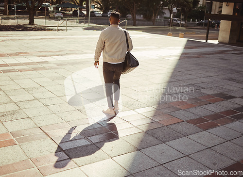 Image of Business, travel and city with a young man walking outdoors against an urban background in the day. Entrepreneur or employee looking for work, a job or ready to start a career on a summer morning