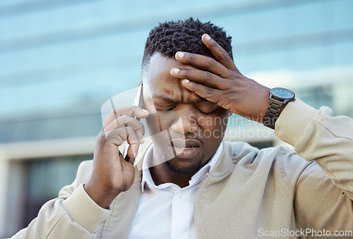 Image of Stressed, pain and tired business man on an annoying phone call outdoors in a city feeling angry and disappointed. Frustrated, unhappy or sick entrepreneur with a headache or migraine