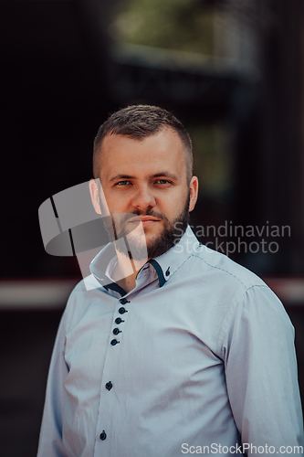 Image of A portrait of a modern man, exuding confidence and style, against an outdoor backdrop, showcasing his charisma and fashionable demeanor.