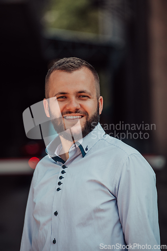 Image of A portrait of a modern man, exuding confidence and style, against an outdoor backdrop, showcasing his charisma and fashionable demeanor.