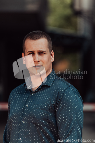 Image of A portrait of a modern man, exuding confidence and style, against an outdoor backdrop, showcasing his charisma and fashionable demeanor.