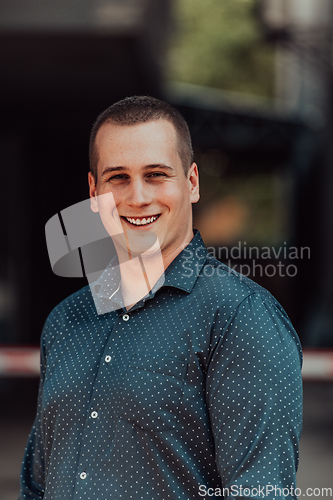 Image of A portrait of a modern man, exuding confidence and style, against an outdoor backdrop, showcasing his charisma and fashionable demeanor.