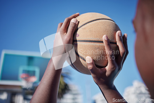 Image of Basketball court, sports man or fitness with motivation, vision or wellness goal in training, workout or exercise. Closeup player or competition athlete hands and basket ball shooting for net in game