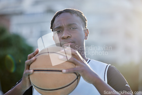 Image of Basketball, cool and a tough player training for a game on a basketball court. Portrait of a serious professional athlete focused on his sport career, looking ready, powerful and assertive