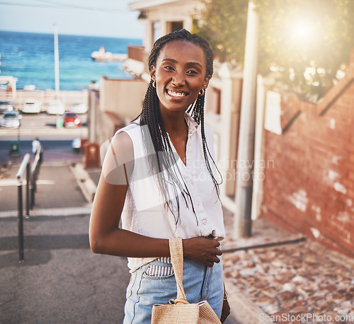Image of Happy smile black woman on vacation in city by sea or ocean water port side on sunshine summer holiday travel. Portrait of joy, excited and smiling black girl person on sun flare urban outdoor street