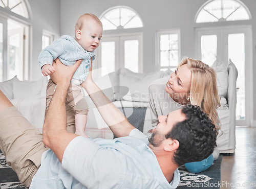 Image of Relax, living room and parents playing with their baby together on the floor of their family home. Love, smile and happy mother and father bonding with their newborn child in the lounge of a house.