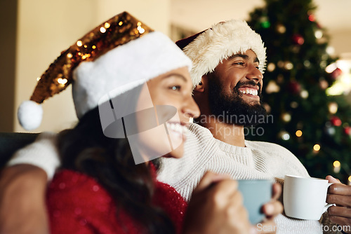 Image of Christmas, couple on couch and hot chocolate with smile or happiness to relax, festive season and at home together in living room. Xmas, love and man with woman, eggnog or loving together for bonding