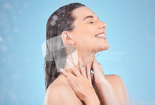 Image of Woman shower, smile and studio with water, washing and cleaning for skincare, cosmetic health or wellness. Happy model, water drops or cosmetics for self care, skin or healthy body by blue background