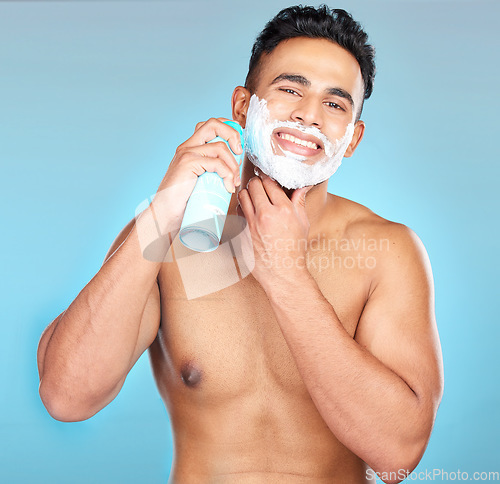 Image of Man, face skincare or shaving cream in grooming routine, hair removal treatment or hair growth management. Portrait, smile or happy model and shave foam in beard wellness on Brazilian blue background