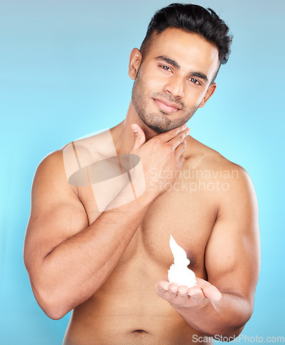 Image of Foam, shave and man portrait with cream for epilation, beauty and skincare or haircare on a blue studio background. Beard, mousse and hair removal with a male for shaving his facial hair