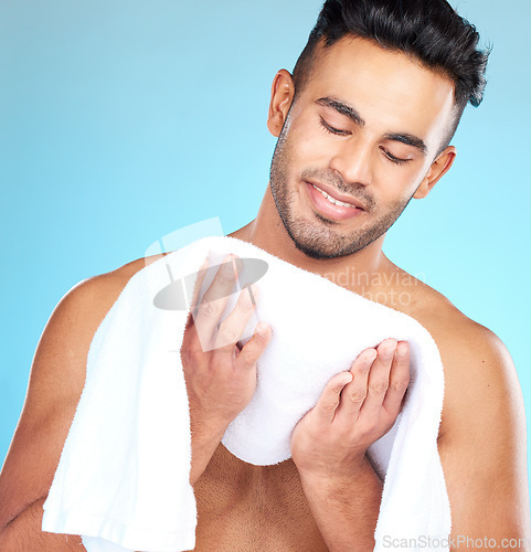 Image of Cleaning, towel and face of man clean after wellness wash, facial cleaning routine and skincare mockup. Happiness, smile and person after bath or shower for body self car on blue studio background
