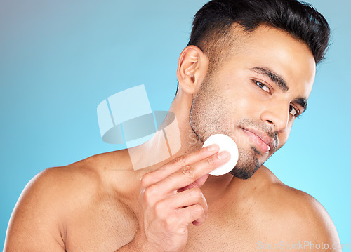 Image of Beauty, skincare and cotton with portrait of man for facial, product and spa cosmetics. Massage, luxury and cleaning with face of model for toner, makeup remover and self care in blue background