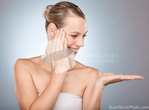 Image of Beauty, skincare and woman in a studio with mockup space for a health, wellness and natural face routine. Cosmetic, healthy and happy girl model with a facial treatment by a gradient gray background.