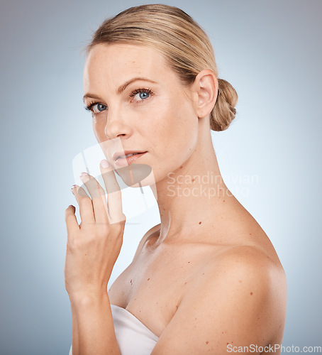 Image of Portrait, skincare and antiaging with a model woman in studio on a gray background to promote a natural product. Face, cosmetics and beauty with an attractive young female inside for skin treatment