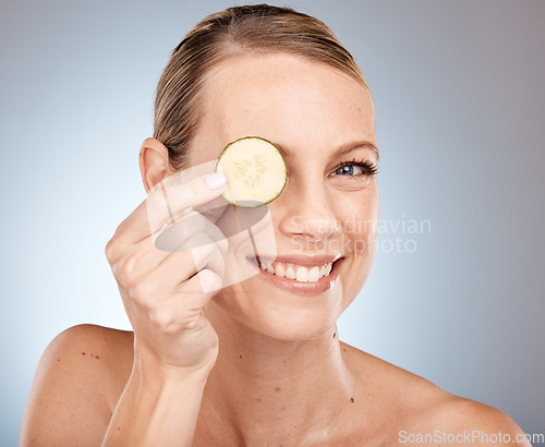 Image of Cucumber eye and skincare portrait of woman with healthy, fresh and clean face satisfaction. Self love, wellness and skin detox model with natural beauty smile on gray studio background.