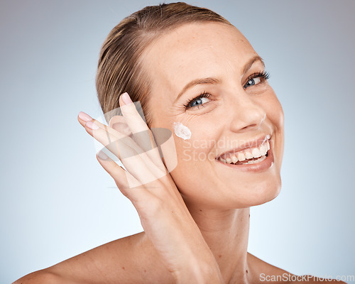 Image of Beauty portrait and woman with skincare cream dot for skin anti aging, health and sunscreen care. Wellness, lotion and self care face of girl with happy smile on gray studio background.