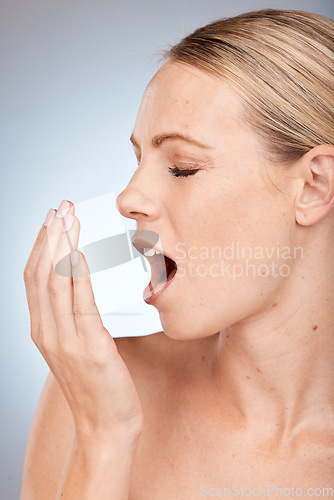 Image of Fresh breath, odor and woman smelling, mouth care and dental hygiene against a grey studio background. Healthcare, oral health and face of a model with hand for smell, problem and dentist treatment