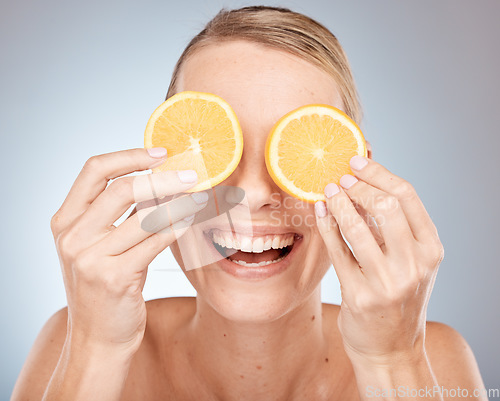 Image of Lemon, eyes and skincare woman in studio for cosmetics, makeup and health of nutrition benefits and results promotion. Happy model with fruits for vitamin c on skin care, dermatology and facial