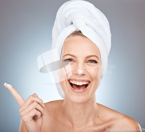 Image of Beauty, skincare and product with portrait of woman and facial cream for shower, luxury and spa. Sunscreen, cosmetics and lotion on face of model with towel for cleaning, moisturizer and dermatology