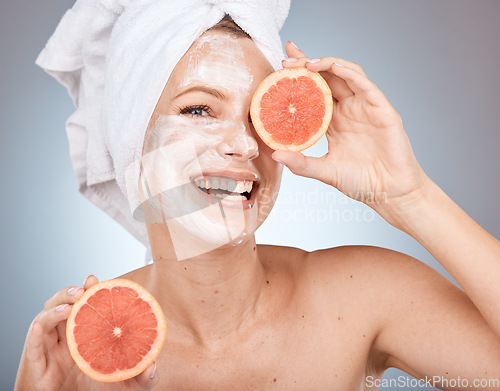 Image of Skincare, grapefruit and portrait of a woman in studio with face cream, lotion or spf for skin routine. Health, wellness and model with citrus fruit for organic, natural and healthy facial treatment.