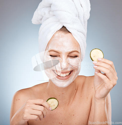 Image of Laughing woman, skincare face mask and cucumber on studio background in acne dermatology, healthcare wellness or self care routine. Happy smile, beauty model and facial vegetables in organic grooming